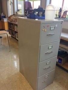 Transform your old metal filing cabinet into a lovely message center! Use wrapping paper to create this easy classroom feature.
